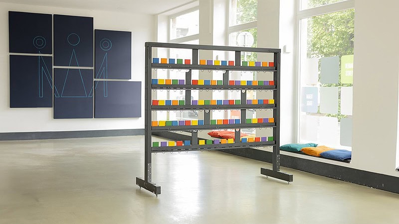 Ein großer heller Raum bei Hall of Game in Dresden. In der Mitte des Raumes steht ein Ständer mit Spielzubehör.