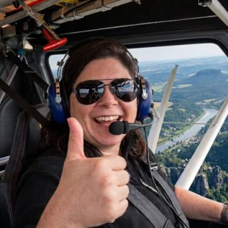 Rundflug Frau zeigt Daumen hoch