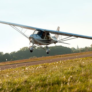 Ultraleichtflugzeug über wiese beim Schnupperkurs Flugzeug selber fliegen