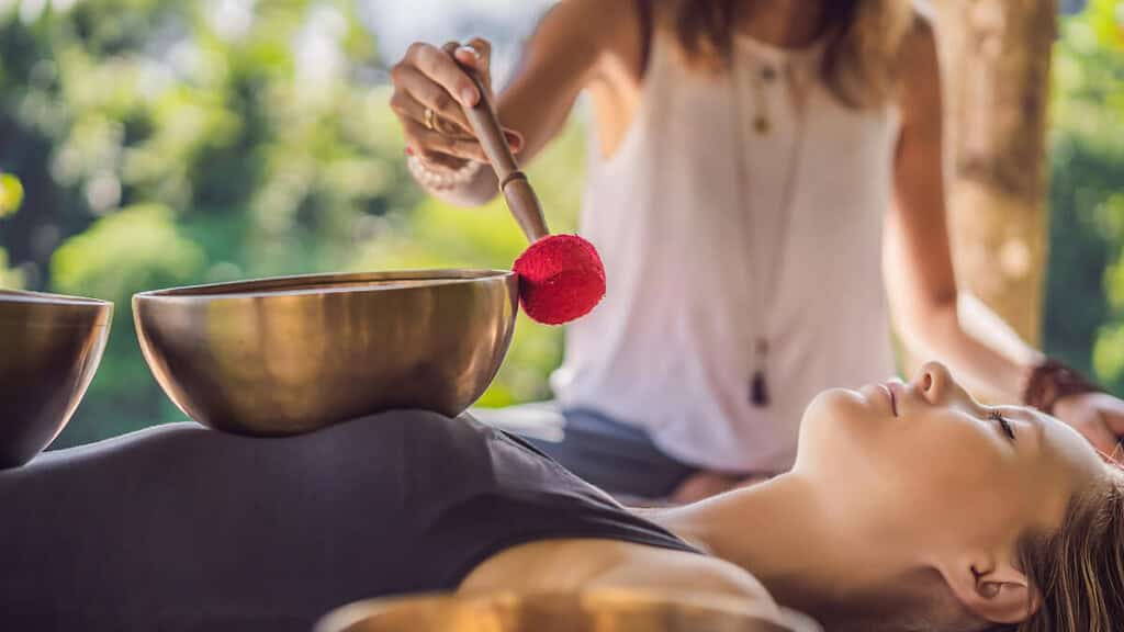 Eine Frau genießt eine Klangschalenmassage.