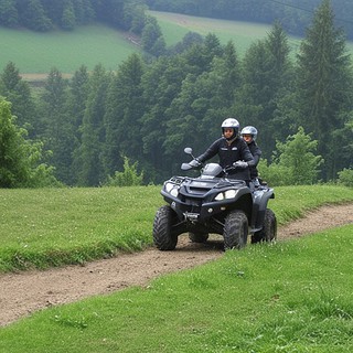 Zwei Personen zusammen auf einem Qaud fahren über den Feldweg