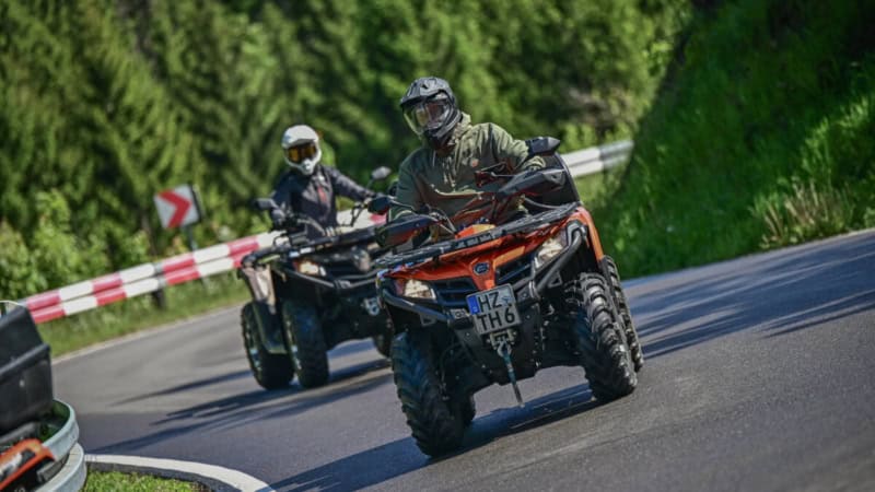 Zwei Fahrer auf Quads die eine kurvige Bergstraße hochfahren im Harzer Gebirge.