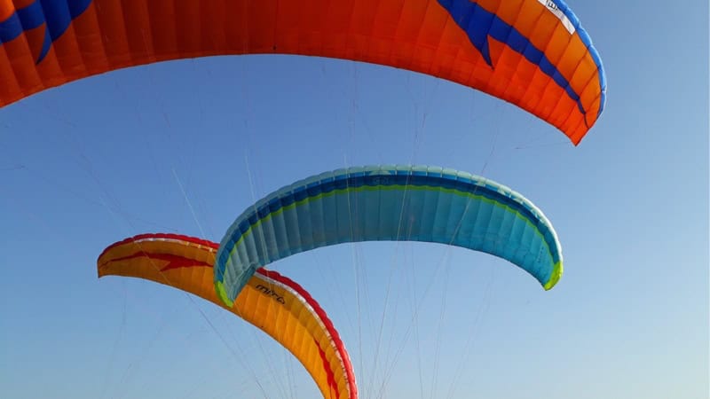 Mehrere Schirme sind am Himmel zu sehen