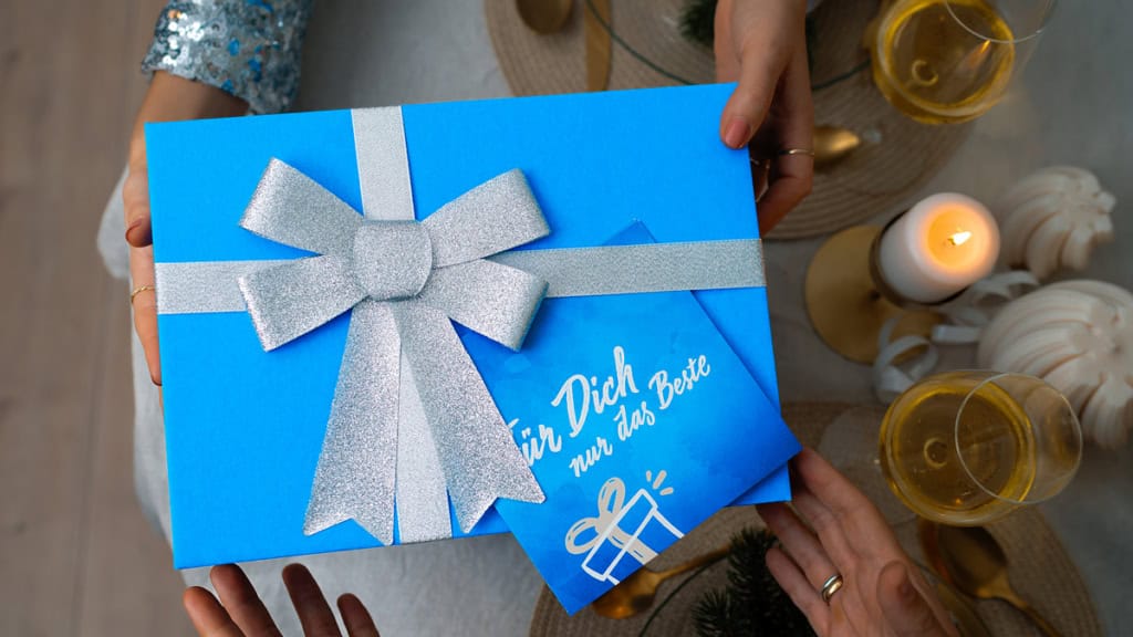 Eine Geschenkbox der Erlebnisfabrik von oben bei der Übergabe.