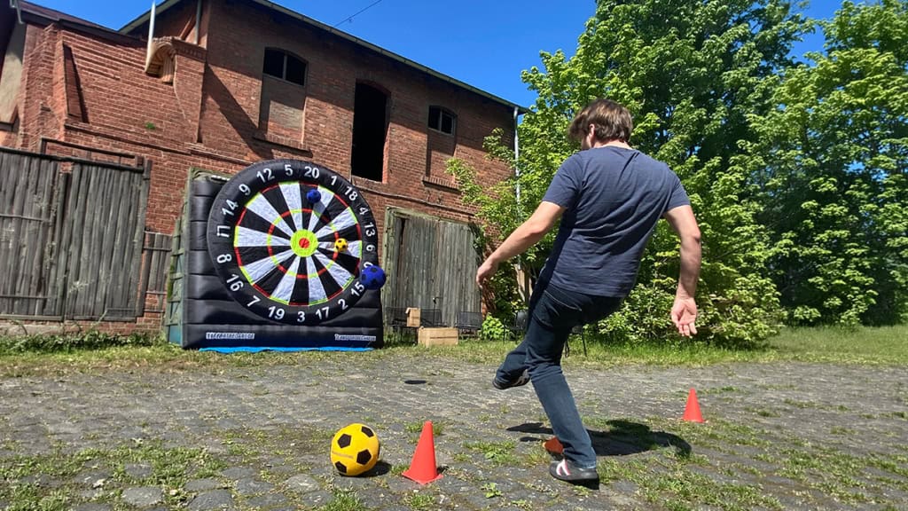 teamrallye_leipzig4 Person schießt einen Fußball auf eine große Dartsscheibe